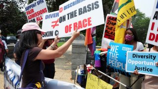 Demonstrators for and against the U.S. Supreme Court decision to strike down race-conscious student admissions programs at Harvard University and the University of North Carolina confront each other, in Washington, June 29, 2023.