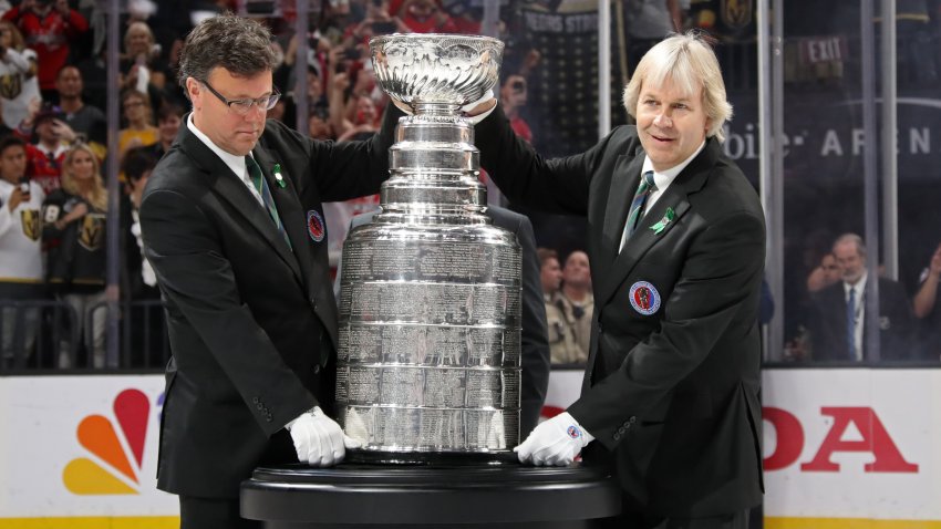 Craig Campbell, left, and Phil Pritchard, The Keepers of the Stanley Cup, bring the Stanley Cup onto the ice after Game 5 of the 2018 NHL Stanley Cup Final between the Washington Capitals and the Vegas Golden Knights at T-Mobile Arena on June 7, 2018 in Las Vegas.