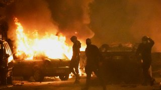 Youths clash with police forces as cars burn in Nanterre, outside Paris, Thursday, June 29, 2023. French President Emmanuel Macron has described the killing of a 17-year-old delivery driver by police at a traffic check “inexcusable,” and called for a thorough investigation. The death in the Paris suburb of Nanterre prompted scattered violence overnight.