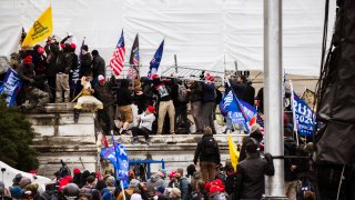 File - A group of pro-Trump protesters climb the walls of the Capitol Building after storming the West lawn on Jan. 6, 2021 in Washington, DC.