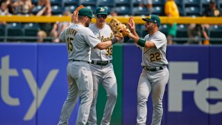 Seth Brown #15, JJ Bleday #33 and Ramon Laureano #22 of the Oakland Athletics.