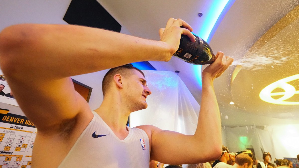 Watch: Nikola Jokic's emotionless champagne pop after Nuggets' NBA Finals win