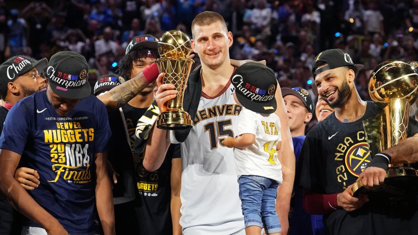 DENVER, CO – JUNE 12: Nikola Jokic #15 of the Denver Nuggets is awarded the Bill Russell MVP trophy after winning Game Five of the 2023 NBA Finals on June 12, 2023 at Ball Arena in Denver, Colorado. NOTE TO USER: User expressly acknowledges and agrees that, by downloading and or using this Photograph, user is consenting to the terms and conditions of the Getty Images License Agreement. Mandatory Copyright Notice: Copyright 2023 NBAE (Photo by Jesse D. Garrabrant/NBAE via Getty Images)