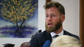 FILE - Owen Shroyer, an InfoWars host and sometimes reporter who is a frequent guest on the "Alex Jones Show," testifies during Jones' defamation damages trial at the Travis County Courthouse, July 29, 2022, in Austin, Texas.