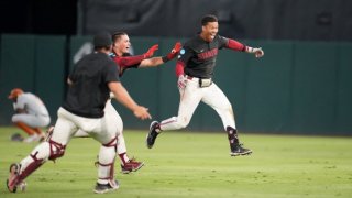 Stanford’s Drew Bowser celebrates with teammates after his game-winning single in the bottom of the ninth sent the Cardinal to the College World Series. (June 12, 2023)