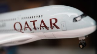 Qatar Airways logo is seen on a plane model.