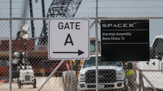 BOCA CHICA, TX – SEPTEMBER 28: A gated entrance by a prototype of SpaceX’s Starship spacecraft is seen at the company’s Texas launch facility on September 28, 2019 in Boca Chica near Brownsville, Texas. The Starship spacecraft is a massive vehicle meant to take people to the Moon, Mars, and beyond. (Photo by Loren Elliott/Getty Images)