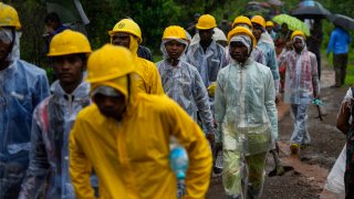 Rescuers walk towards the site of a landslide in Raigad district, western Maharashtra state, India, Thursday, July 20, 2023. While some people are reported dead many others feared trapped under piles of debris. (AP Photo/Rafiq Maqbool)