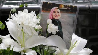 FILE – A photo of Summer Taylor, who suffered critical injuries and died after being hit by a car while protesting over the weekend, sits among flowers at the King County Correctional Facility, July 6, 2020, in Seattle.