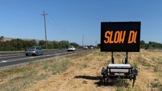A sign urges drivers to slow down on Santa Teresa Boulevard in the Coyote Valley, near where a young mountain lion was found dead along the roadway. (July 13, 2023)