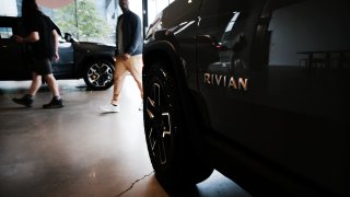 People walk by electric truck maker Rivian’s newly opened storefront in the Meatpacking District of Manhattan, New York City, June 23, 2023.