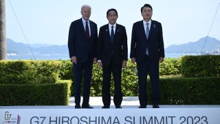 US President Joe Biden, Japan’s Prime Minister Fumio Kishida, and South Korea’s President Yoon Suk Yeol pose for photos ahead of their trilateral meeting during the G7 Leaders’ Summit in Hiroshima on May 21, 2023. (Photo by Brendan SMIALOWSKI / AFP) (Photo by BRENDAN SMIALOWSKI/AFP via Getty Images)