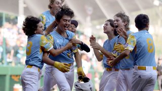 Louis Lappe of the West Region team from El Segundo, California celebrates with teammates after hitting a walk-off home run to defeat the Caribbean Region team from Willemstad, Curacao during the Little League World Series Championship Game at Little League International Complex on Aug. 27, 2023 in South Williamsport, Pa.