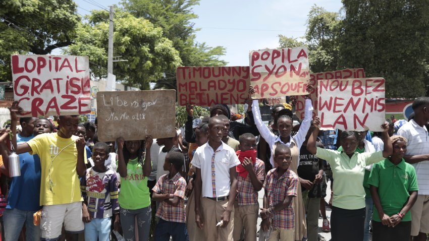 Students from the El Roi academy carry signs during a demonstration to demand the freedom of New Hampshire nurse Alix Dorsainvil and her daughter, who have been reported kidnapped, in the Cite Soleil neighborhood of Port-au-Prince, Haiti, Monday, July 31, 2023. Dorsainvil works for the El Roi Haiti nonprofit organization and the U.S. State Department issued a “do not travel advisory” ordering nonemergency personnel to leave the Caribbean nation amid growing security concerns.