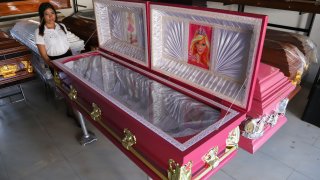 Pink colored coffins featuring a Barbie motif are displayed at a funeral home in Ahuachapan, El Salvador, Friday, Aug. 4, 2023. According to the funeral home manager, the idea was well received as a joyful atmosphere to the loss of a loved one.