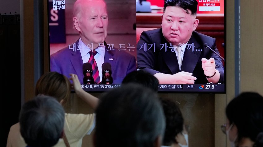 A TV screen shows file images of U.S. President Joe Biden, left, and North Korean leader Kim Jong Un during a news program reporting on American soldier Travis King, at the Seoul Railway Station in Seoul, South Korea, Saturday, July 22, 2023.