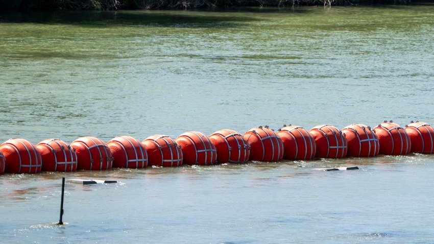 Buoys are placed on the water along the Rio Grande border with Mexico in Eagle Pass, Texas, on July 15, 2023, to prevent migrants from entering the US. The buoy installation is part of an operation Texas is pursuing to secure its borders, but activists and some legislators say Governor Greg Abbott is exceeding his authority.