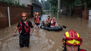 ZHUOZHOU, CHINA – AUGUST 03: Rescue workers and local residents work in an area inundated with floodwaters on August 3, 2023 near Zhuozhou, Hebei Province south of Beijing, China. Disaster response teams have been working to control floodwaters and help stranded residents after the strongest storm in years battered northern China. The extreme rainfall from Typhoon Doksuri was the heaviest to hit Beijing in 140 years, inundating the capital and triggering flash floods and landslides. In nearby Hebei province, officials said floodwaters could take a month to recede.  More than 100,000 people were evacuated from the hard-hit city of Zhuozhou, where rescuers used rafts to reach people trapped in villages cut off by deep water.