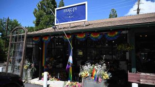 A Pride flag ripped off its flag pole is seen outside the entrance to the Mag.Pi clothing store is seen in Cedar Glen, near Lake Arrowhead, California, on Aug. 21, 2023.