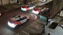 Cell phone image overlooking a San Francisco Street at nighttime showing several Cruise robotaxis stopped on Vallejo Street in San Francisco's North Beach.