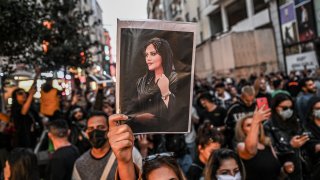 A protester holds a portrait of Mahsa Amini during a demonstration in support of Amini, a young Iranian woman who died after being arrested in Tehran by the Islamic Republic’s morality police, on Istiklal avenue in Istanbul on Sept. 20, 2022.