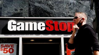 A man passes by a GameStop location on 6th Avenue in New York, March 23, 2021.