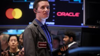 Traders work on the floor of the New York Stock Exchange, July 12, 2023.