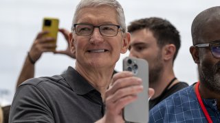 Tim Cook, chief executive officer of Apple Inc., holds an iPhone 15 Pro Max during an event at Apple Park campus in Cupertino, California, US, on Tuesday, Sept. 12, 2023. 