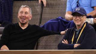 Oracle Co-founder Larry Ellison, left, and Microsoft Co-founder Bill Gates watch a match between Gael Monfils of France and Alexander Zverev of Germany during the BNP Paribas Open in Indian Wells, Calif., on Oct. 13, 2021.