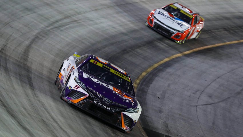 Denny Hamlin, driver of the No. 11 FedEx Freight Direct Toyota, and Kyle Larson, driver of the No. 5 Valvoline/Hendrickcars.com Chevrolet, race during the NASCAR Cup Series Bass Pro Shops Night Race at Bristol Motor Speedway on Sept. 16, 2023 in Bristol, Tenn.