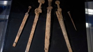 Israeli archaeologists show four Roman-era swords and a javelin head found during a recent excavation in a cave near the Dead Sea, in Jerusalem, Wednesday, Sep. 6, 2023.