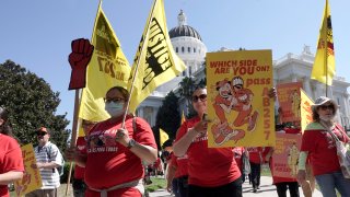 Fast food workers and their supporters march past the California state Capitol in Sacramento, Calif., on Aug. 16, 2022. Most fast food workers in California would get a $20 minimum wage under a new bill introduced in the state legislature, Sept. 11, 2023. The bill represents an agreement between labor unions and the fast food industry.