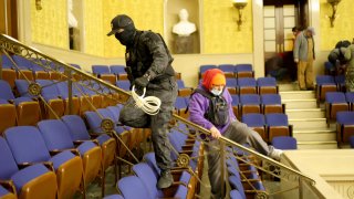 Protesters enter the Senate Chamber