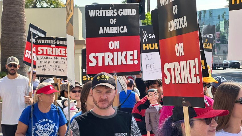 LOS ANGELES, CALIFORNIA – SEPTEMBER 22: Picketers walk the picket line outside Paramount Studios on September 22, 2023 in Los Angeles, California. Members of SAG-AFTRA and WGA (Writers Guild of America) have both walked out in their first joint strike against the studios since 1960. The strike has shut down a majority of Hollywood productions with writers in the fourth month of their strike against the Hollywood studios.  (Photo by David Livingston/Getty Images)