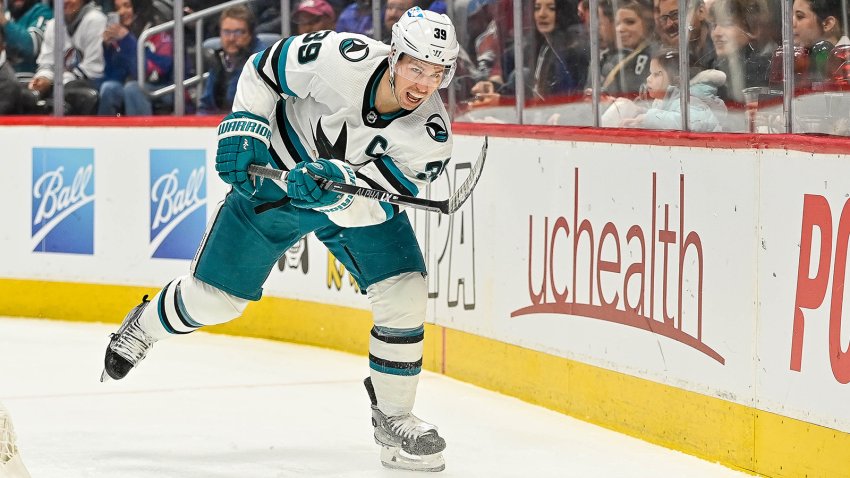 DENVER, COLORADO – MARCH 7:  Logan Couture #39 of the San Jose Sharks works to clear the puck from behind the net in a game at Ball Arena on March 7, 2023 in Denver, Colorado. (Photo by Dustin Bradford/Getty Images)