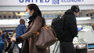 Passengers check in for United Airlines flights at O’Hare International Airport in Chicago on Dec. 13, 2022.