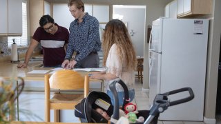 Ryan Ratliff, center, real estate sales associate with Re/Max Advance Realty, shows Ryan Paredes, left, and Ariadna Paredes a home for sale in Cutler Bay, Florida, on April 20, 2023.