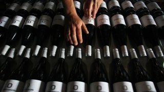 Adrian Brayne, a second-generation winemaker and owner of boutique wine label ‘Obsession Wines’, handles wine stock in the processing building at Obsession Wines on November 24, 2020 in Tumbarumba, Australia.