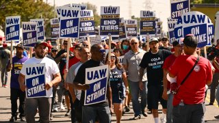 Members of the United Auto Workers (UAW) Local 230 and their supporters walk the picket line in front of the Chrysler Corporate Parts Division in Ontario, California, on September 26, 2023, to show solidarity for the “Big Three” autoworkers currently on strike. 