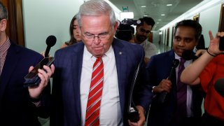 Sen. Robert Menendez is trailed by reporters after attending a Senate Judiciary Committee hearing on federal judge nominations on Capitol Hill in Washington, D.C., on Oct. 4, 2023.