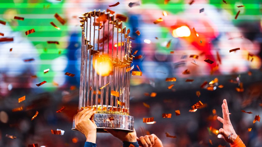 Members of the Houston Astros hoist up the Commissioners Trophy after the Astros defeated the Philadelphia Phillies in Game 6 of the 2022 World Series on November 5, 2022 at Minute Maid Park in Houston, Texas.