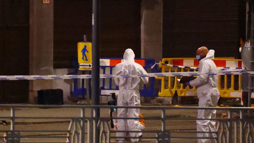 Belgian police officers from the forensic service search for evidence in a street after two people were killed during a shooting in Brussels on October 16, 2023 evening by a suspect who is on the run, the Belgian capital’s prosecutor’s office said. The alleged gunman in a fluorescent orange jacket fled the scene after using an automatic rifle, according to a video shared by Flemish newspaper Het Laatste Nieuws. A spokeswoman for the prosecutor’s office said an investigation had been opened but did not speculate on the gunman’s motive.