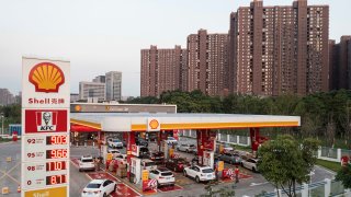 In this aerial view, cars line up to refuel before the price rises at a Shell gas station in Wuhan, the capital of the Hubei province in China, June 14, 2022.