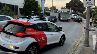 This Cruise in San Francisco seemingly could not figure out how to pull aside on a narrow street to let a buss pass.