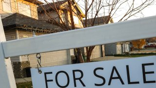 A “For Sale” sign outside a house in Edmonton, Alberta, in Canada on Oct. 22, 2023.