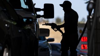 A customer holds a fuel nozzle at a Shell gas station in Hercules, California, U.S., on Wednesday, June 22, 2022. President Joe Biden called on Congress to suspend the federal gasoline tax, a largely symbolic move by an embattled president running out of options to ease pump prices weighing on his party’s political prospects. Photographer: David Paul Morris/Bloomberg via Getty Images