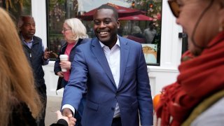 Rhode Island Democratic candidate for the U.S. House Gabe Amo, center, greets people during a campaign stop at a cafe Monday, Nov. 6, 2023, in Providence, R.I.