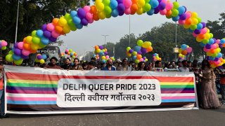 Participants of the Delhi Queer Pride Parade carry a banner.