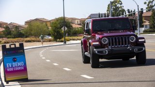 A Jeep Wrangler 4xe plug-in hybrid electric SUV is test driven in Irvine, California, on Sept. 18, 2021.