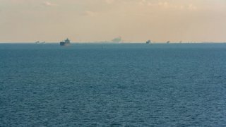 FILE - Cargo ships queuing to pass the Suez Canal
